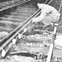 Resistance fighter plants explosives on a railway line in France. Catalogue reference: HS 7/135