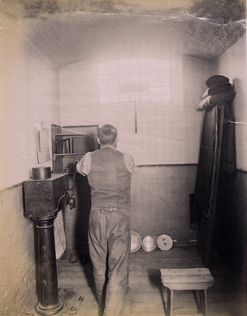 Photograph of prisoner at hard labour in his cell at Wormwood Scrubs Prison. (COPY 1/420 f.171)