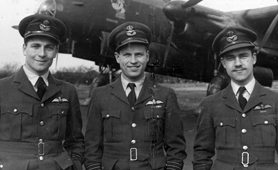 Photograph of three officers standing in front of a plane (Catalogue reference: AIR 27/839)