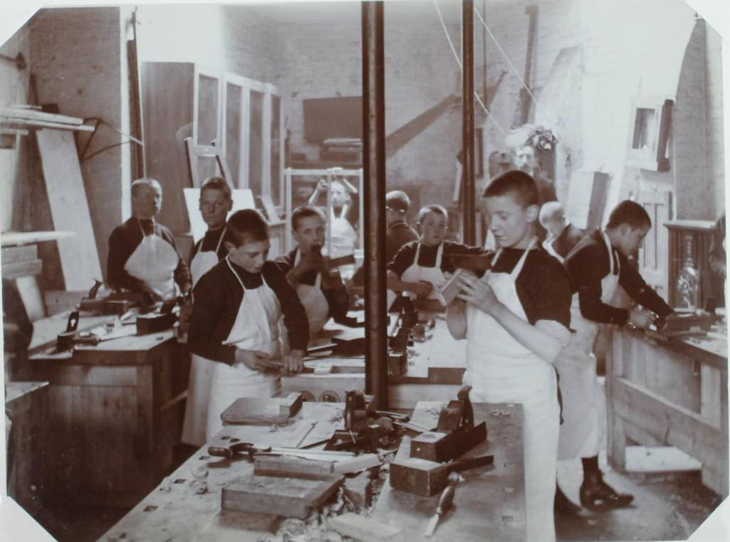 Image of a black and white photograph of children in a school workshop 