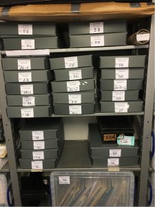 Archives boxes on shelves at the Clevedon Pier Community Archive