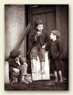 Three school boys wearing caps, rough woollen jackets, vests and knee-pants or rolled trousers but they have no shoes. From the beginning of compulsory education, there were always boys prepared to 'mooch off' and take an unauthorised holiday. Ref:COPY 1/436, Part 2