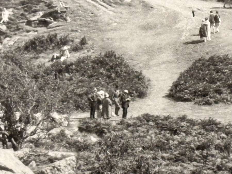A black and white photo of people standing together outside.