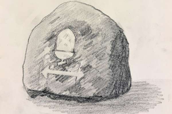 A stretch of a stone with an acorn drawn on to it.