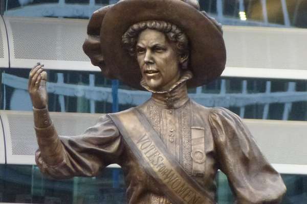 A bronze statue of Alice Hawkins holding up her fist