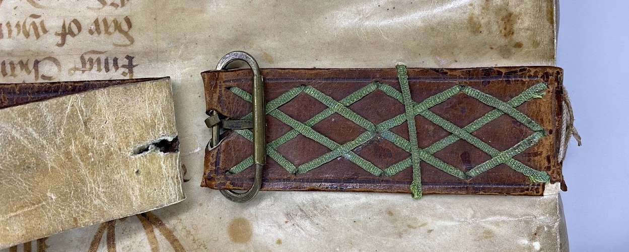 A close up of a buckle binding around a book