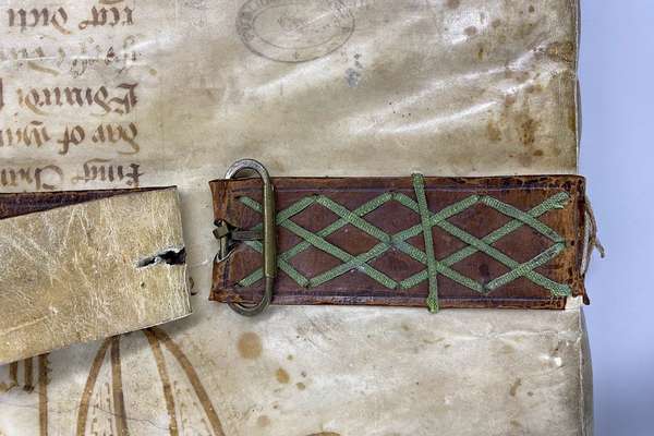 A close up of a buckle binding around a book
