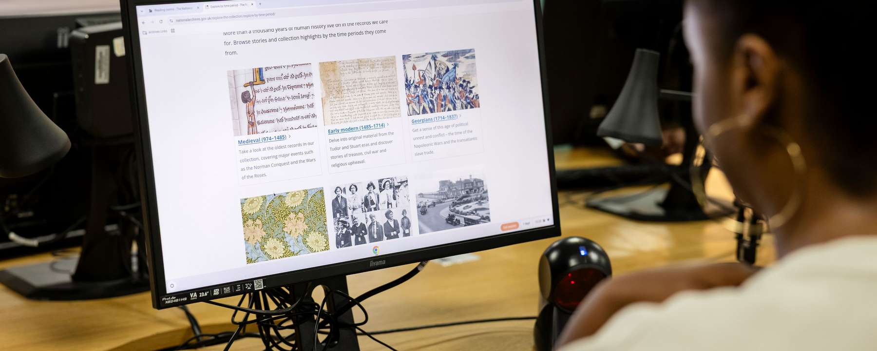 A visitor conducts research on a computer.