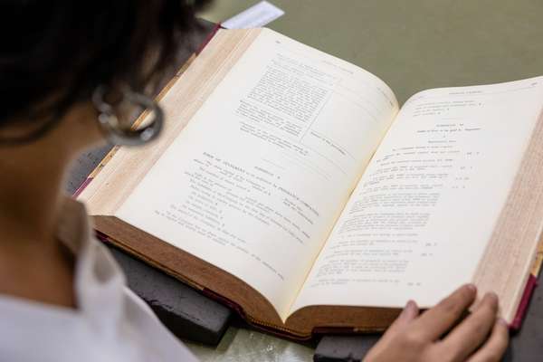 A person reads a large book.