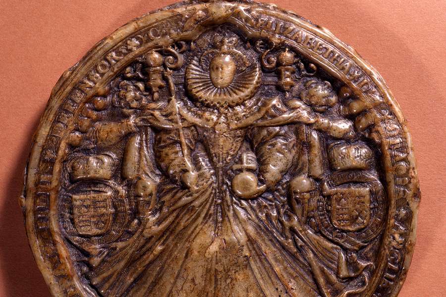 A large intricate wax seal depicting Elizabeth I holding an orb and sceptre.
