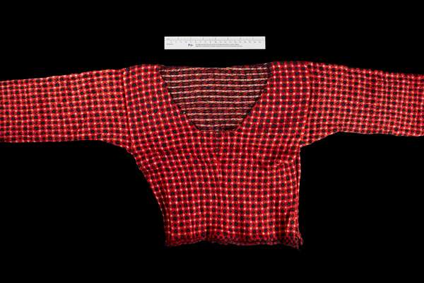 A red sweater on a black background from the Prize Papers collection.
