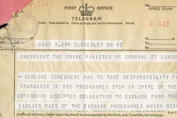 A telegram. A top corner is ripped. Strips of printed text stuck to a telegram form.