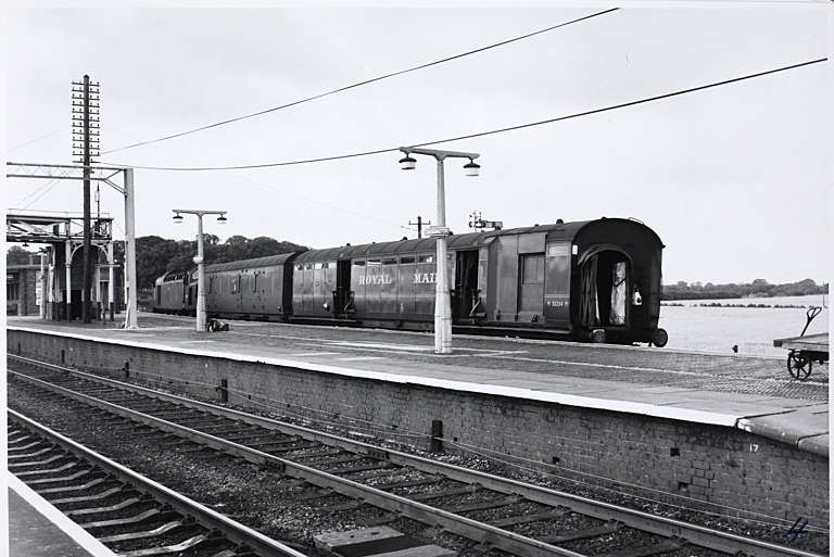 Photograph of a train at a station with Royal Mail written on the side.