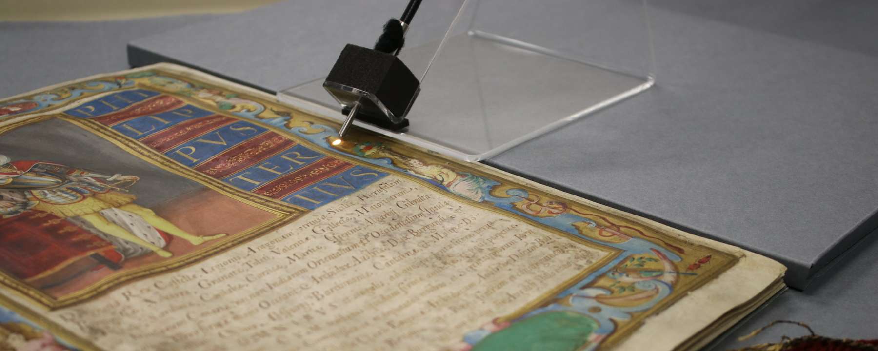 A small scientific instrument points a beam of light on a brightly coloured record