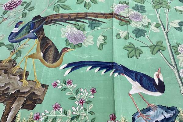 Colourful Chinese painted wallpaper with birds and flowers on a green ground