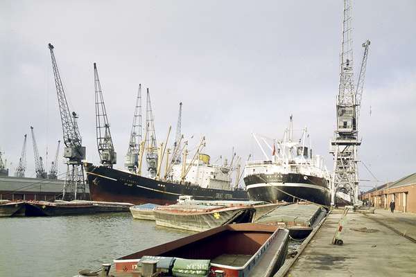 A photograph of a ferry and cranes on Tilbury docks.