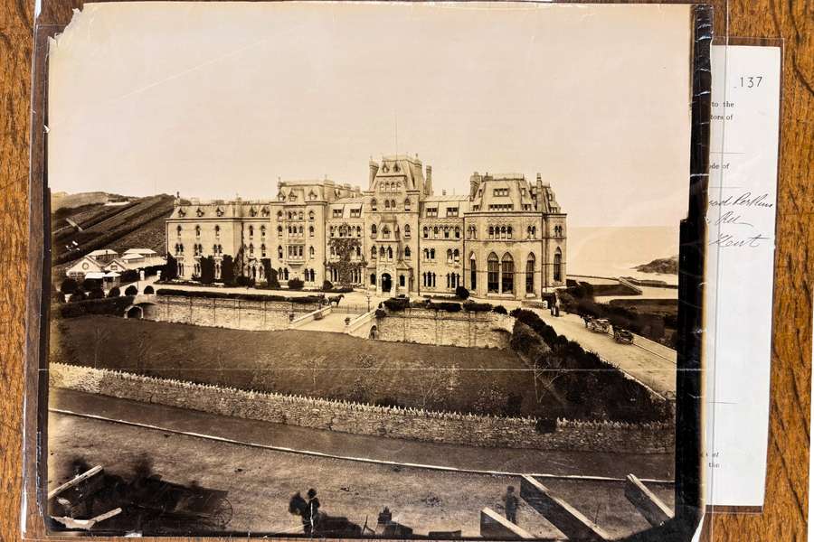 A black and white photo of a large white building.