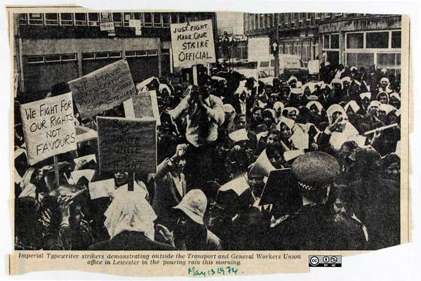 A newspaper clipping showing a photograph of a large group of strikers holding packards.