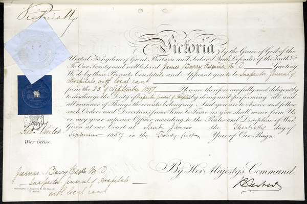 A royal warrant. An official document written in a fine looping script with 'Victoria' in large ornate letters at the top.