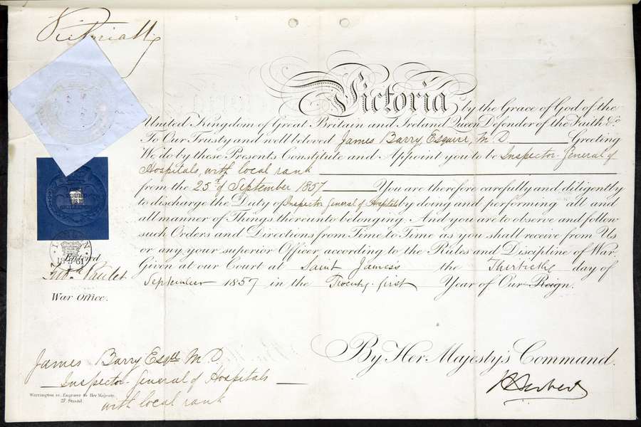 A royal warrant. An official document written in a fine looping script with 'Victoria' in large ornate letters at the top.