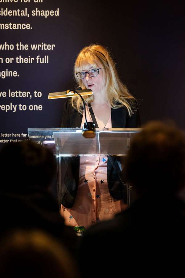 An expert standing at a lectern speaking to an audience.