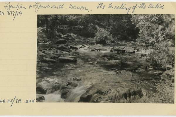 Black and white photograph of flowing water. Handwritten text reads, 'The meeting of of the waters'