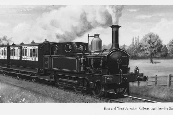 A steam train travelling through the countryside.