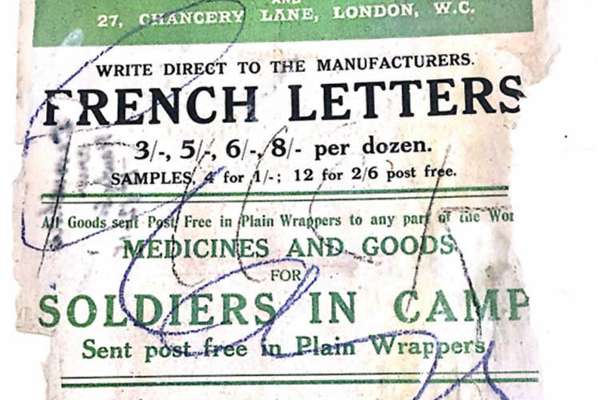 A poster filled with writing. The bottom is torn and the writing has been scribbled over in pen.