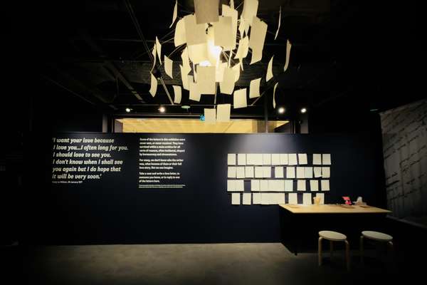 A dimly lit area with letters hung up on a wall. A display of blank letters is hanging above.