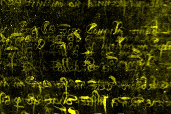 A scanned roll exposing writing, yellow after being scanned. The background is black.