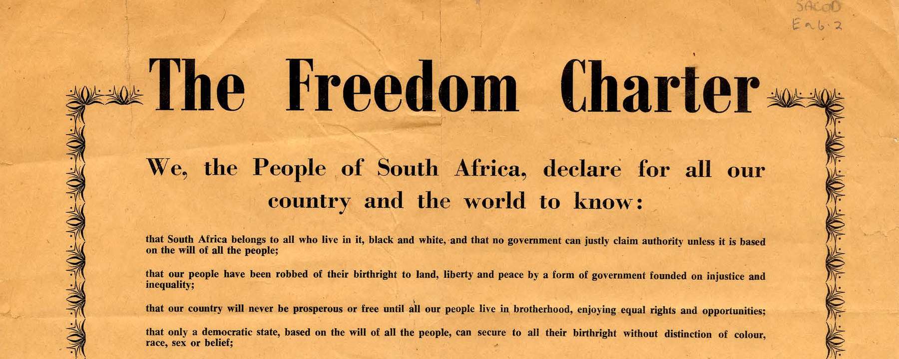 A poster on bright orange paper with a decorative border, filled with printed text setting out the Charter's demands.
