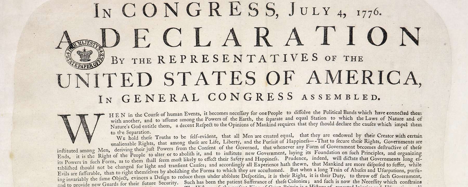 The top half of an original copy of the US Declaration of Independence. The heading reads: 'In Congress, July 4, 1776. A Declaration by the Representatives of the United States of America, in General Congress assembled.'