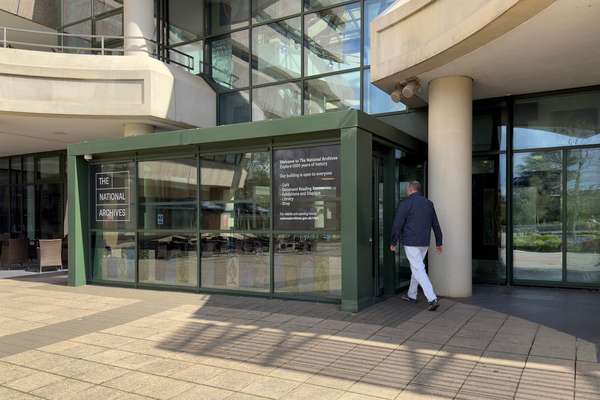 A visitor walks towards the entrance doors in to The National Archives.