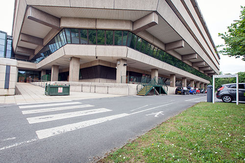 View of accessible parking bays and rear entrance ramp at the rear entrance of the National Archives building.