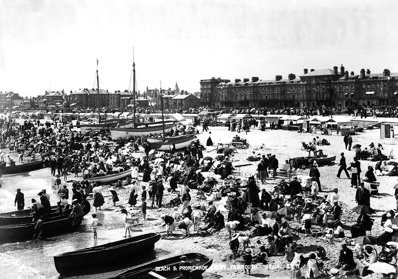 A large crowd in Victorian clothing on a beach.