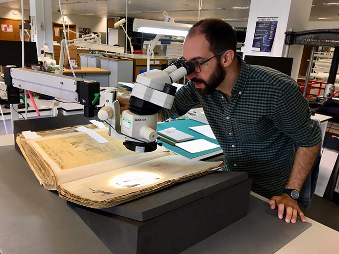 Ioannis examining a pannotype in a Design Register under the microscope.