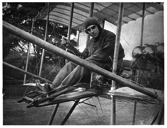 Claude Grahame White, a pioneer of aviation, in 1910 sat in an early aircraft (catalogue reference COPY 1/548/279).