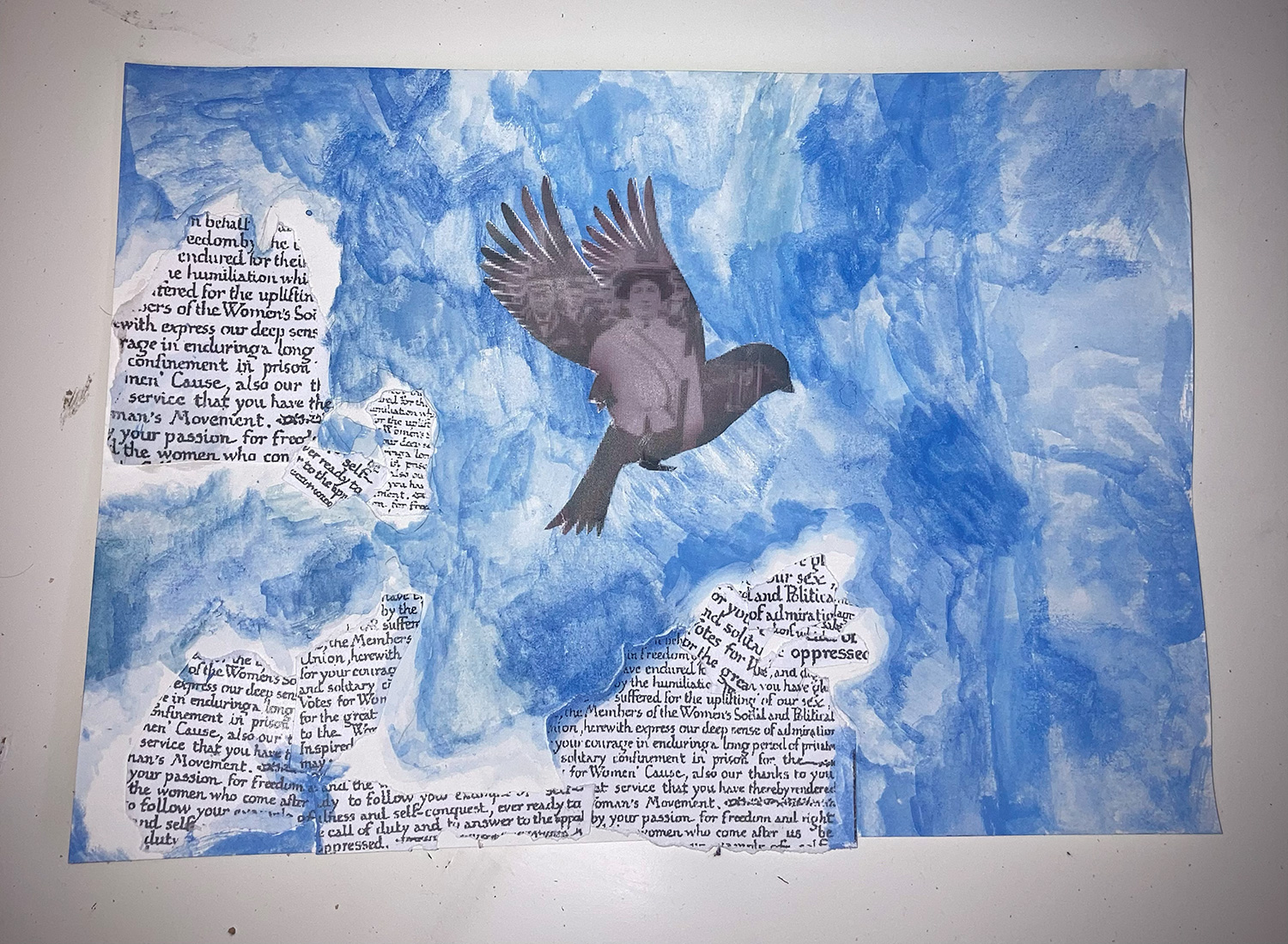 Painting of a bird silhouette in a blue sky. Text from the suffragette movement is placed like clouds in the sky.