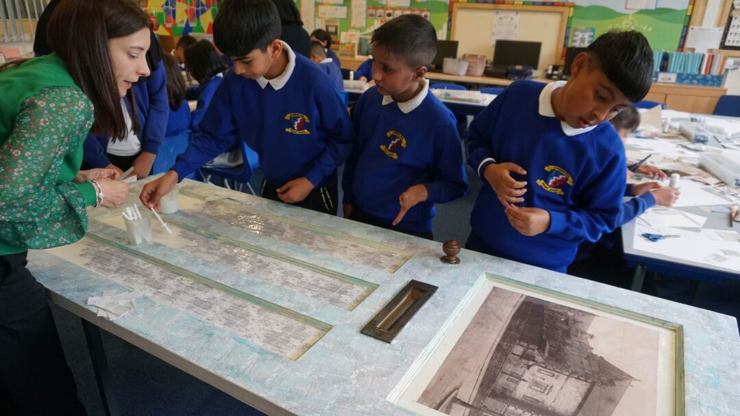 Students in Accrington glue map details to a door