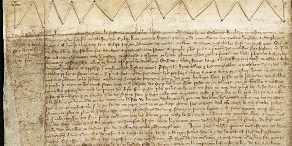 Section of the Treason Act 1352 - beige parchment roll with French writing on it, the medieval language of law