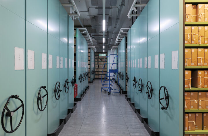 View of a corridor with dozens of shelves containing rows of document boxes.