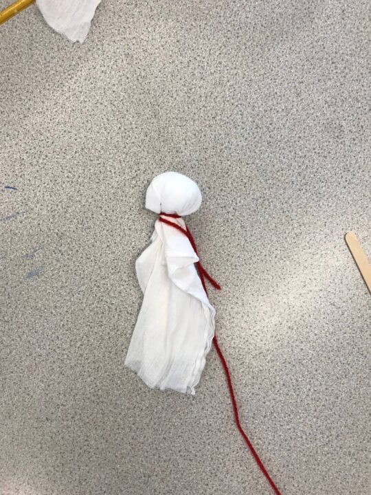 Photograph showing a piece of fabric tied around a cotton wool ball