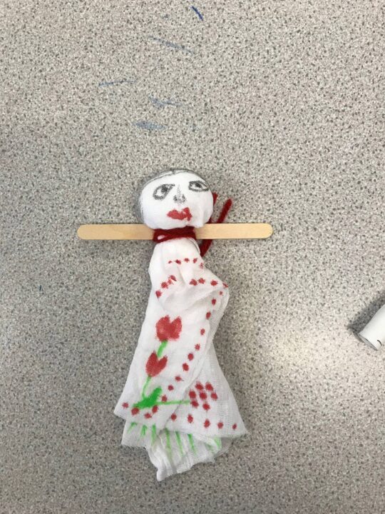 Finished bibi doll with a face drawn and decorated body