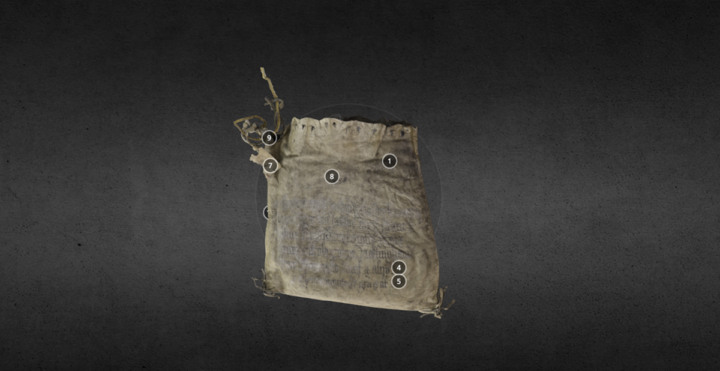 A medium-sized leather bag. The opening is at the top and has holes along it where a string used to go to pull it closed. It has a tassel on each bottom corner and a knotted drawstring in one corner of the opening. A tag is attached to the drawstring.