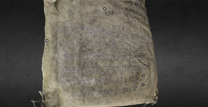 Close-up on the faded Latin inscription on the front of the bag.