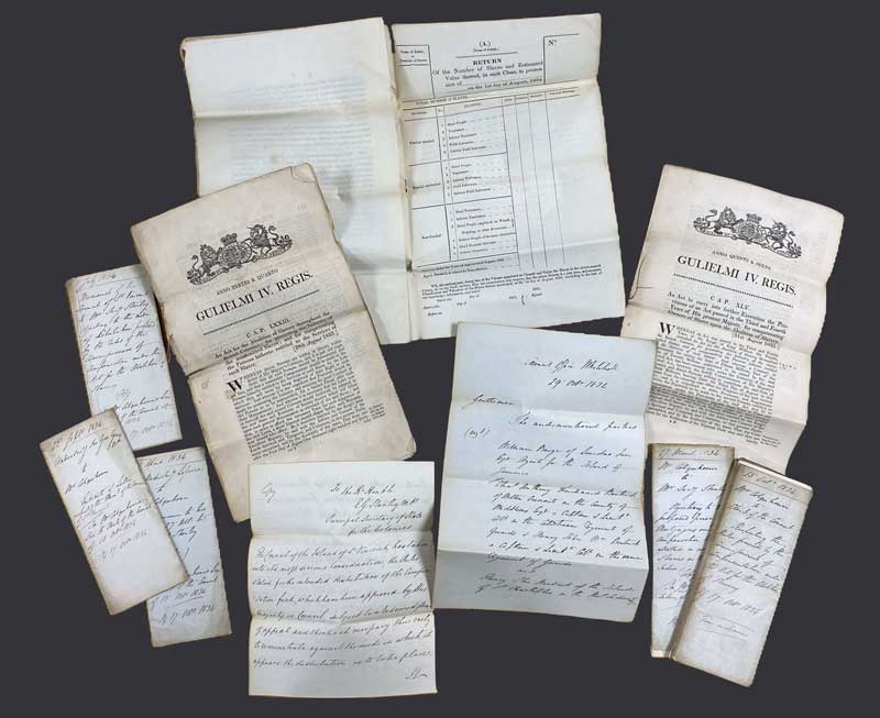 collection of printed and written papers of different sizes, including a large form.
