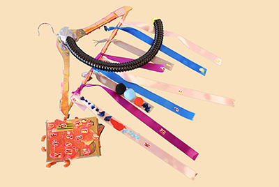 Hanger with multiple colourful ribbons attached, as well as a black tube.
