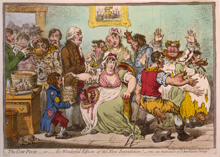 A boy in ragged clothes holds a container of the cowpox vaccine and in his pocket is a paper on the ‘Benefits of the Vaccine’. There is a tub on the desk called ‘Opening mixture’. A bottle next to the tub is labelled ‘vomit’. A man is standing next to the boy injecting a seated worried looking women extending her arm. She is wearing a white cap with ribbon. She is surrounded by a small group of people showing the bodies of small cows sprouting from their arms or faces. One man has grown a pair of horns. A painting on the wall shows ‘Worshippers of the Golden Calf’.