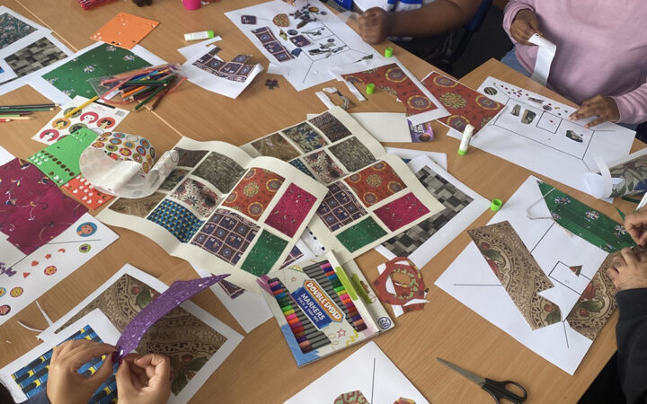 Hands of people working on the ideal room activity.