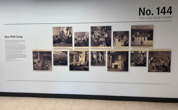 A display of photographs on wall alongside the heading: Kew POW Camp. There is text written under the heading. There are 12 photos in total each showing people going about their day, some eating, some working, at a camp in Kew during the Second World War. 